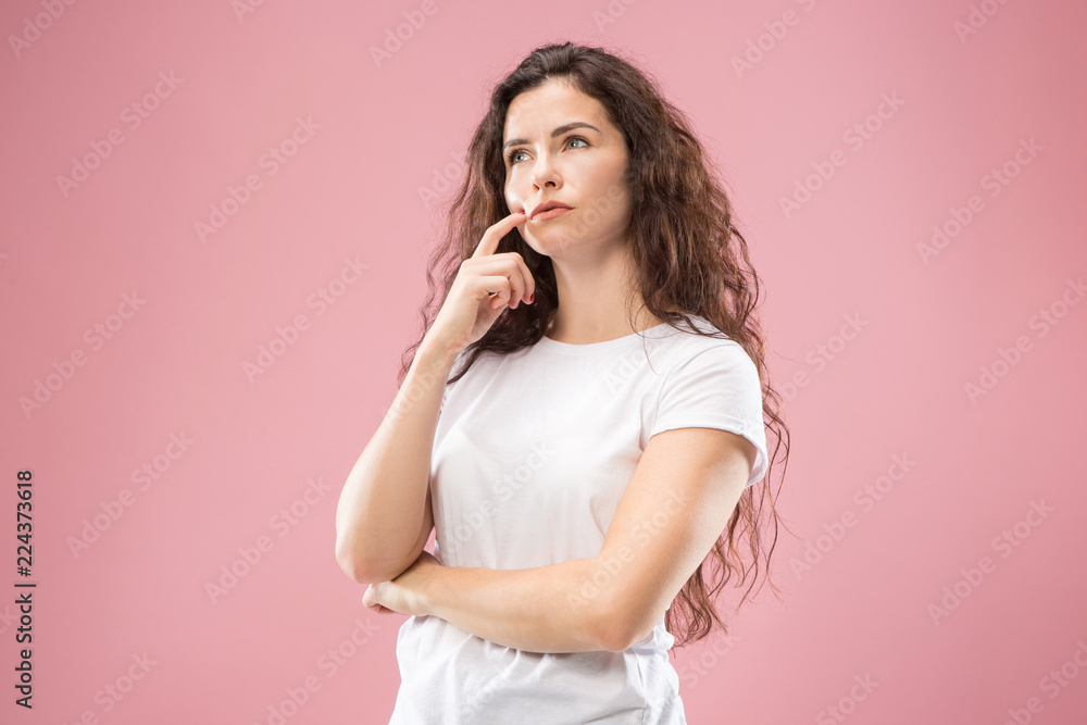 Remember all. Let me think. Doubt concept. Doubtful, thoughtful woman remembering something. Young emotional woman. Human emotions, facial expression concept. Studio. Isolated on trendy pink. Front - obrazy, fototapety, plakaty 