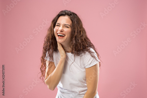 Happy business woman standing and smiling isolated on pink studio background. Beautiful female half-length portrait. Young emotional woman. The human emotions  facial expression concept. Front view.