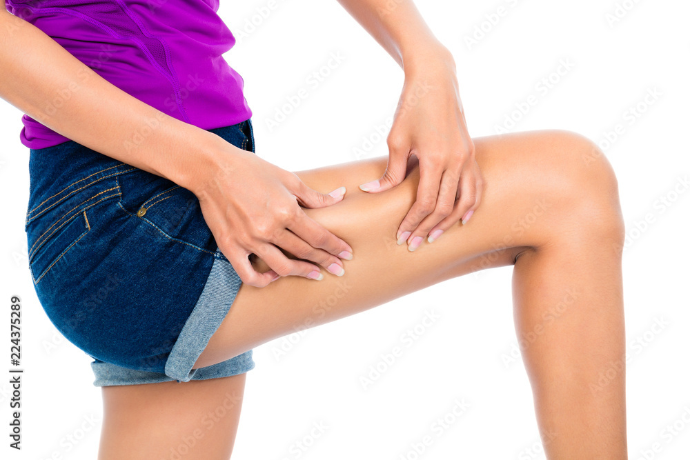 Close-up of a woman holding her thigh skin