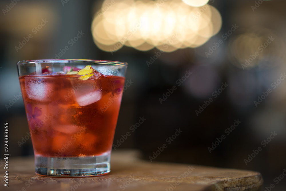 Tea of rosewater on wooden table. Cafe lighting bokeh background concept. Tea of rosewater on wooden table. Cafe lighting bokeh background concept.