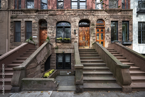 a row of colorful brownstone buildings in an iconic neighborhood  of Manhattan New York