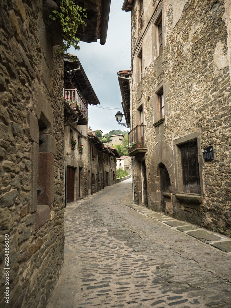 A paved street in the Catalan village of Rupit i Pruit in summertime