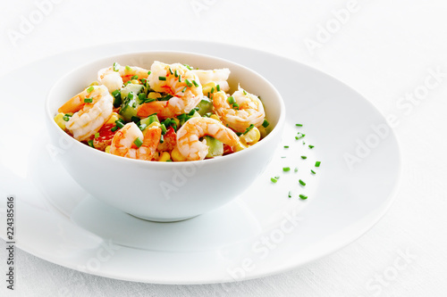 seafood, cucumber,corn, and bell pepper salad dressed with mayonnaise and decorated with green onion