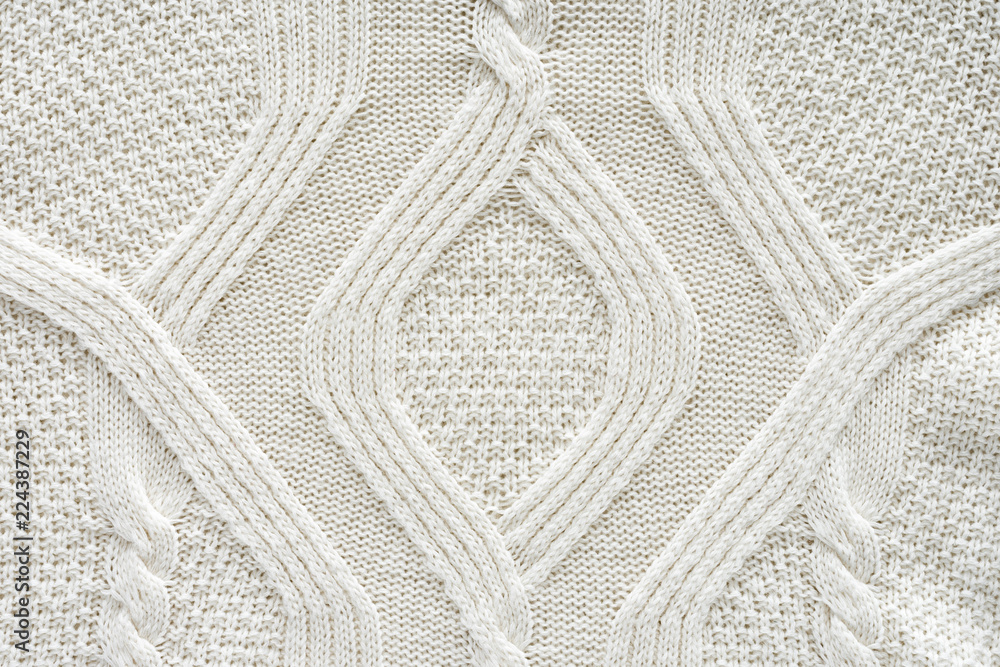 full frame of white knitted cloth with pattern as background