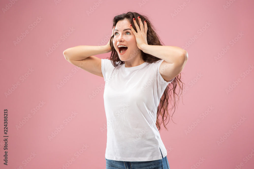 Wow. Beautiful female half-length front portrait isolated on pink studio backgroud. Young emotional surprised woman standing with open mouth. Human emotions, facial expression concept. Trendy colors Wow. Beautiful female half-length front portrait isolated on pink studio backgroud. Young emotional surprised woman standing with open mouth. Human emotions, facial expression concept. Trendy colors