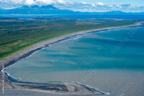 Aerial photography view of Alaska's Katmai National Park. Teal water, lush green mountain vegetation and sandbars into the Cook Inlet photo