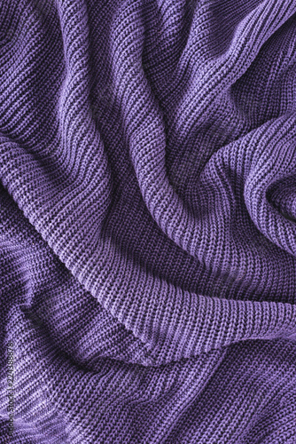 full frame of purple folded woolen fabric as background photo