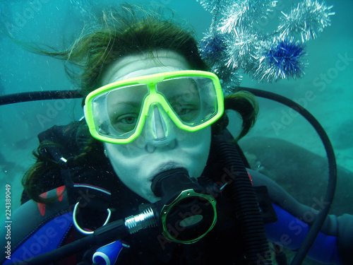Wallpaper Mural The portrait of young woman with scuba diving equipment: mask, regulator and accessories on her heir. She is underwater, she looks forward.  Torontodigital.ca