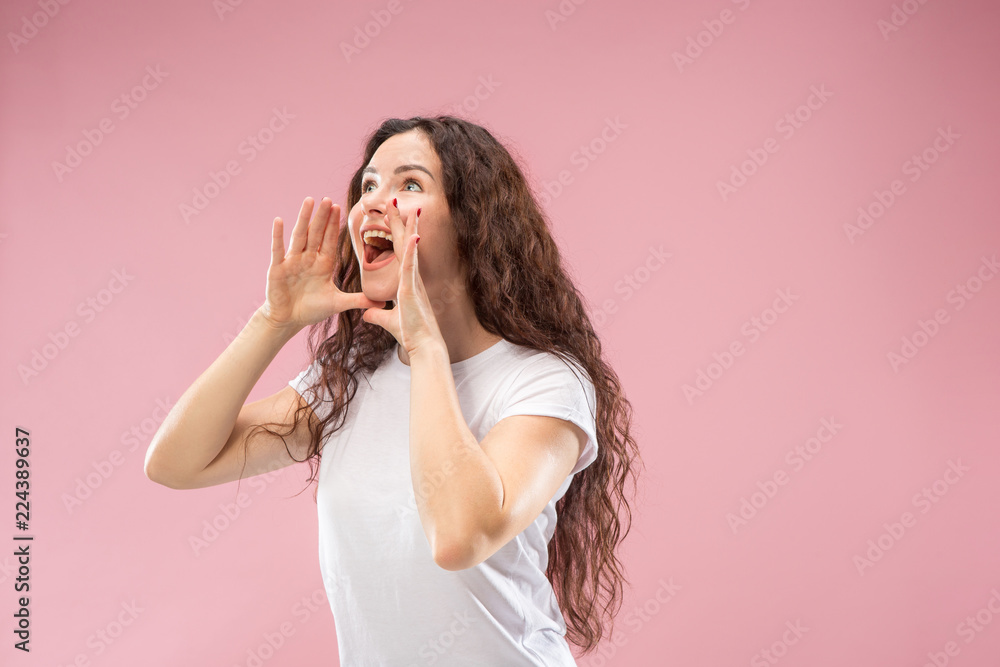 Do not miss. Young casual woman shouting. Shout. Crying emotional woman screaming on studio background. Female half-length portrait. Human emotions, facial expression concept. Trendy colors Do not miss. Young casual woman shouting. Shout. Crying emotional woman screaming on studio background. Female half-length portrait. Human emotions, facial expression concept. Trendy colors