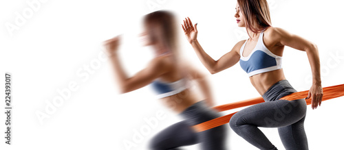 Young sporty woman using a resistance band.