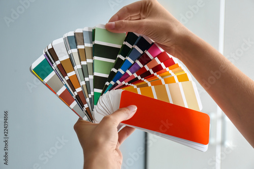 Female interior designer with color palette samples indoors, closeup © New Africa