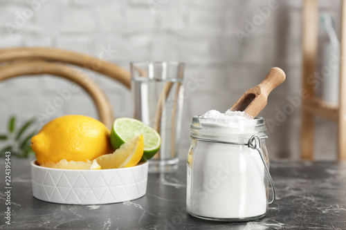 Fototapeta Naklejka Na Ścianę i Meble -  Jar with baking soda and lemons on table indoors