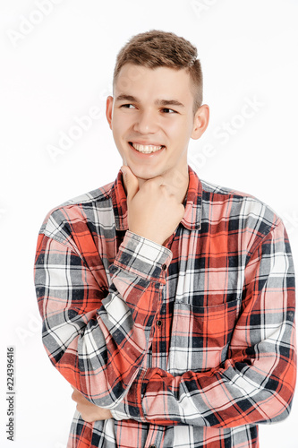 Portrait of a boy in a photo studio. Young Man posing on a white background.