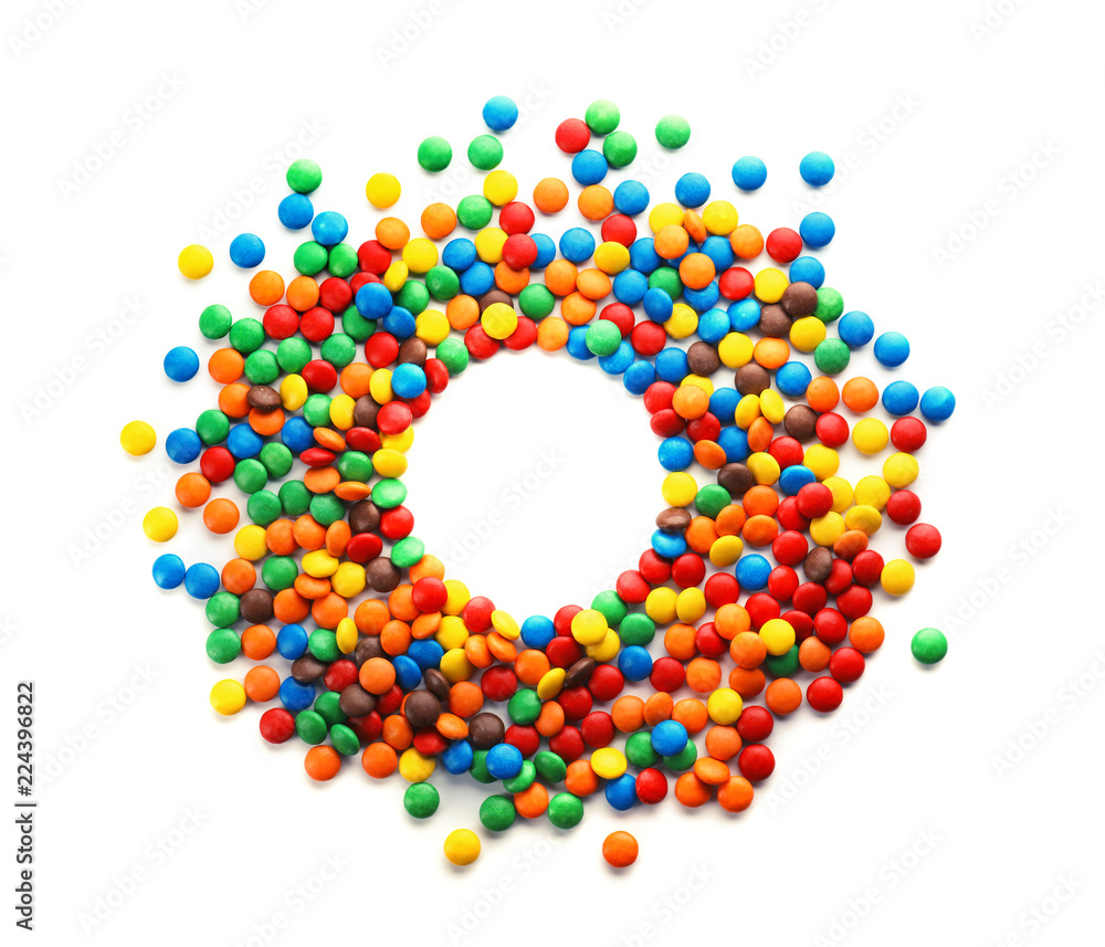 Frame made of colorful candies on white background, top view. Space for text