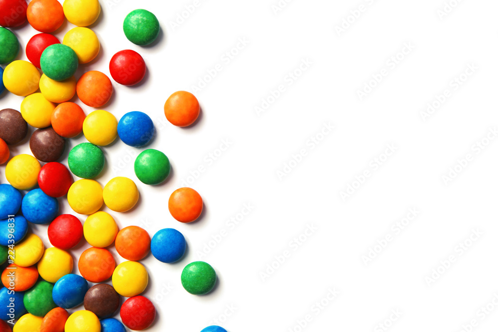 Obraz premium Tasty colorful candies on white background, top view
