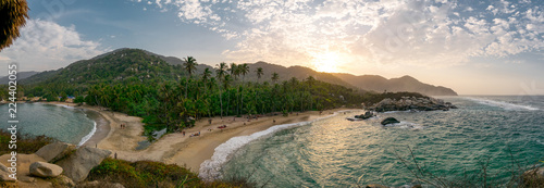 Beautiful Caribbean beach with palm trees and sunset in Tayrona National Park close to Santa Marta in Northern Colombia photo