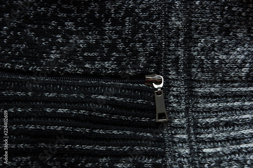 warm gray light dark gradient woolen sweater pocket lock zipper wool close-up. © Konstantin