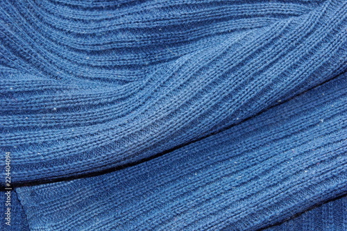 warm blue dark woolen sweater fabric texture background wool close-up.
