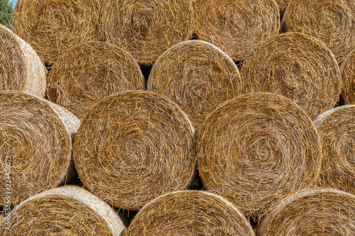 Round bales of hay stacked in a pyramid shape. Close up.