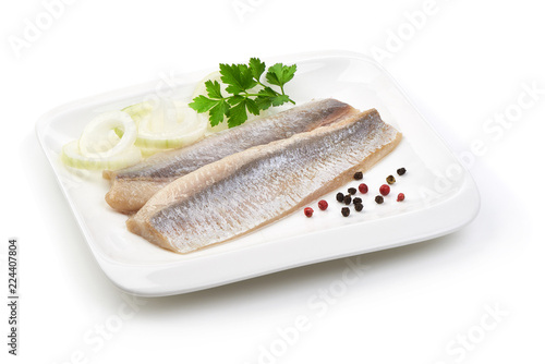 Fotografie Fillet of salted marinated Atlantic herring with onion, peppercorns and parsley, isolated on white background