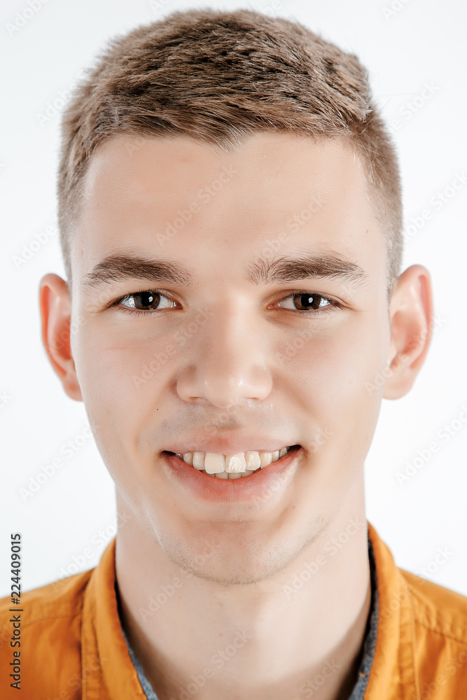 Obraz premium Portrait of a boy in a photo studio. Young Man posing on a white background.