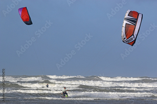 kitesurfers riding in waves