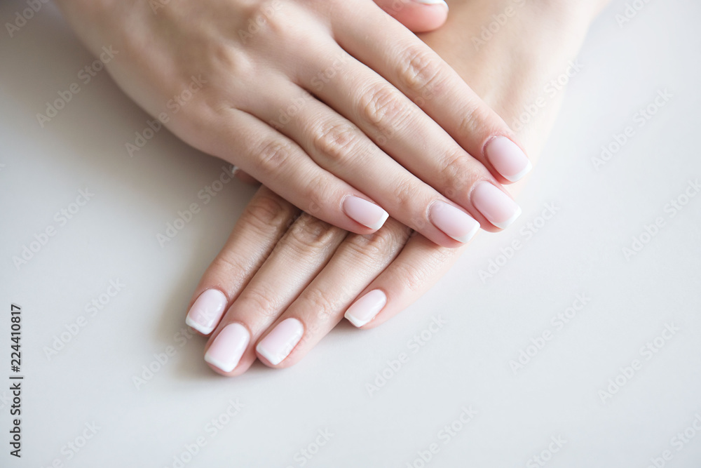 Manicured hands on towel. French manicure. Manicured hands on towel. French manicure.