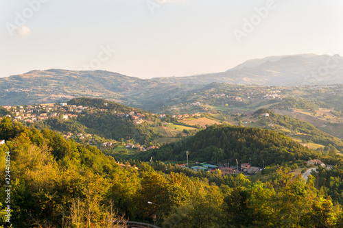 view of San Marino with houses, fields, woodland and mountains