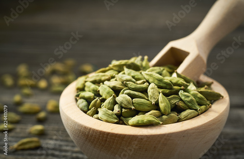 Green cardamom pods  on a gray wooden background photo