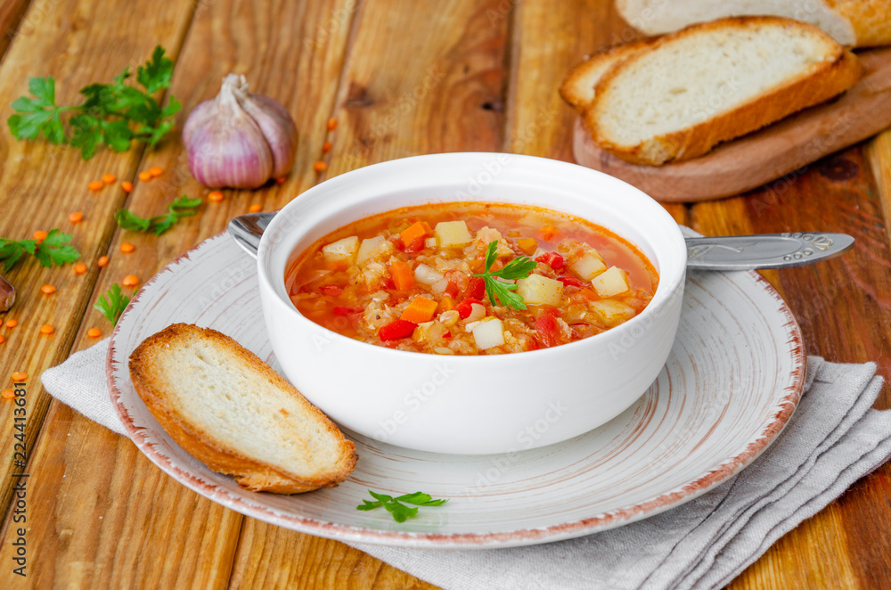Spicy soup with red lentils, tomatoes, leek, bell pepper, carrots and potatoes. Spicy soup with red lentils, tomatoes, leek, bell pepper, carrots and potatoes.