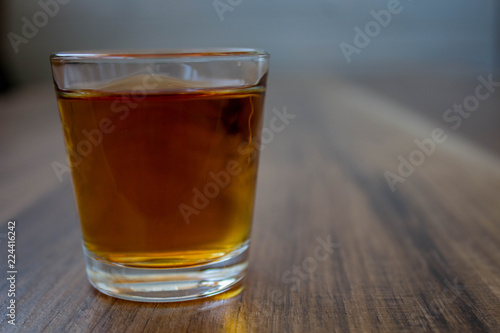 a pile of whiskey on a wooden background