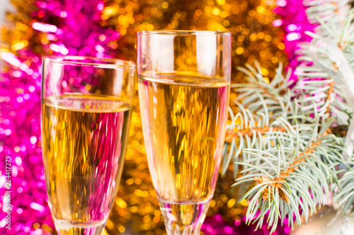 Background of Glasses with champagne and pink and gold garland