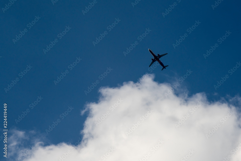 The plane flies in the clouds The plane flies in the clouds