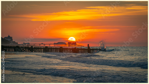 Pier sunset on the beach photo