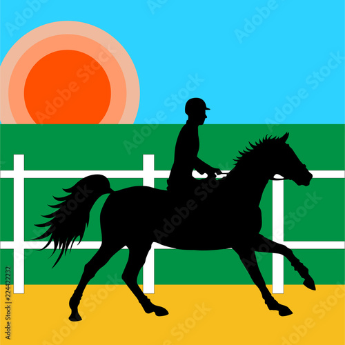Rider horseback in the riding hall under the rising sun