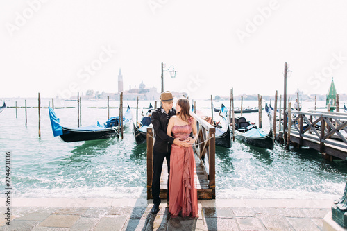 Italy beauty, pretty girl and boy with San Giorgio Maggiore and boat behind, Venezia, Venice © sofiko14