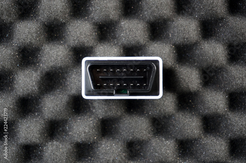 Small OBD2 interface on black foam photo