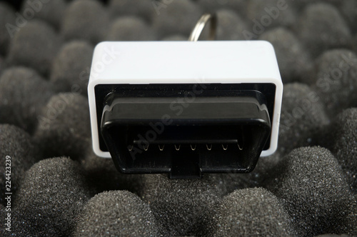 Small OBD2 interface on black foam