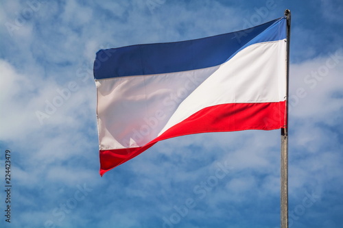 Free Download The national flag of the Republic of Crimea is fluttering in the wind against the sky - GFXLoad