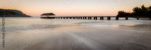 Fototapeta Naklejka Na Ścianę i Meble -  Hanalei bay beach pier at sunrise with water streaks in the sand