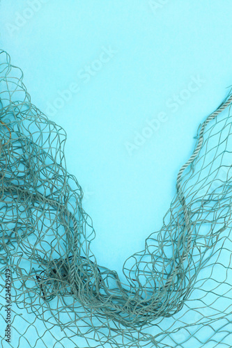 Fishing net with space for your text. Blue background for a fishery theme.