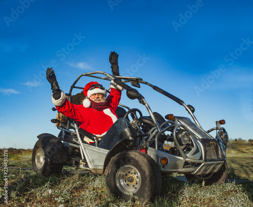 Happy new year and merry Christmas greetings. Salutation of Santa Claus in a buggy car with his hands up. Happy Christmas concept, space for text.