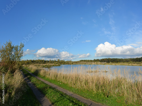 Sunny autumn day on the shore of an artificial lake. © zoya54