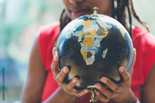 Woman hand holding globe photo