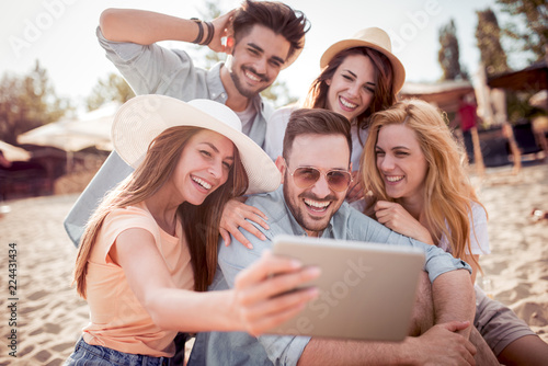 Group of friends taking a selfie with tablet ,having fun © ivanko80