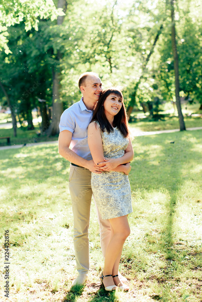 Fototapeta premium young loving couple walking in the park outdoors