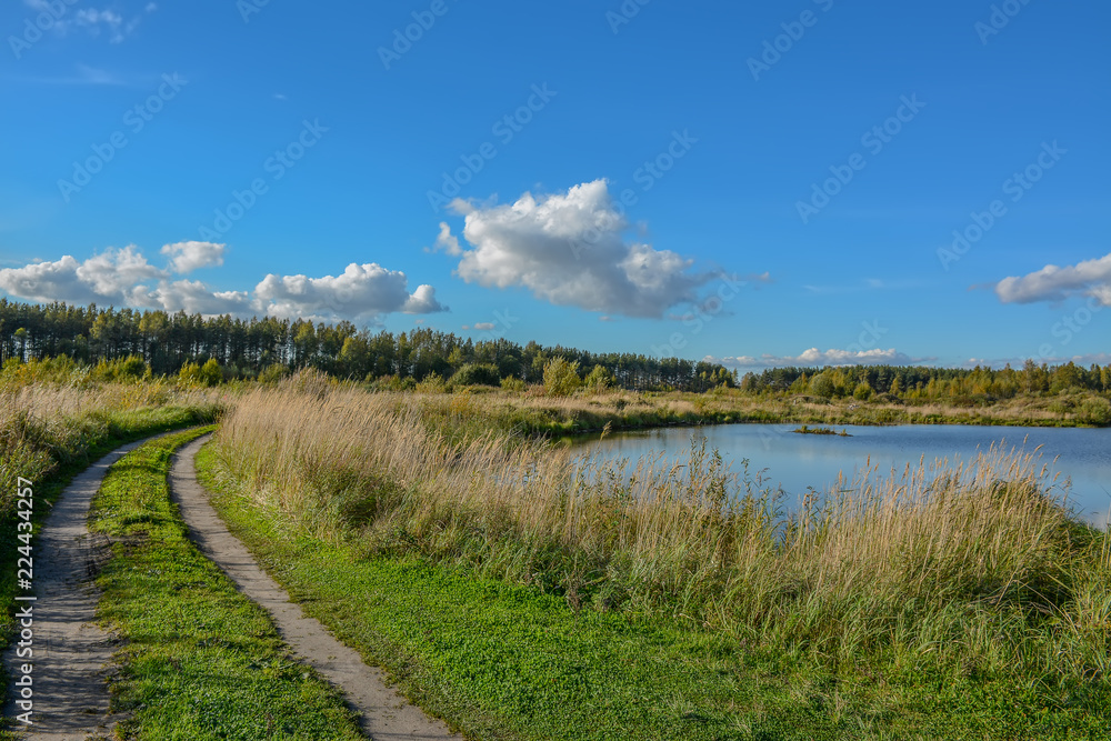 Sunny autumn day on the shore of an artificial lake.