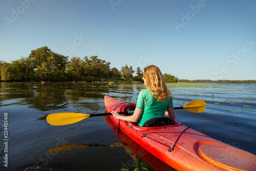 Woman in a kayak on a river