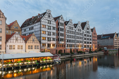 Gdansk evening cityscape. Buildings on the bank of the Motlawa River with their reflections in water.