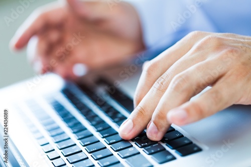 Closeup of a Businessman Typing on a Laptop